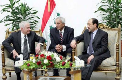 
U.S. Defense Secretary Robert Gates, left, meets Iraqi Prime Minister Nouri al-Maliki, right, in Baghdad on Friday. Gates said the U.S.'s commitment was 