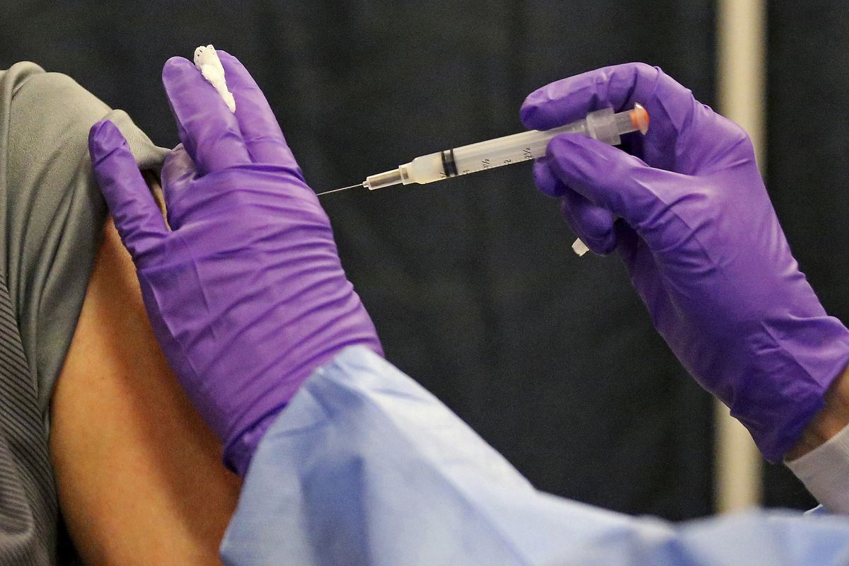 FILE - A man gets a COVID-19 vaccine at a mass vaccination site at the Natick Mall on Wednesday, Feb. 24, 2021, in Natick, Mass. U.S. experts are expected to recommend COVID-19 vaccine boosters for all Americans, regardless of age, eight months after they received their second dose of the shot, to ensure lasting protection against the coronavirus as the delta variant spreads across the country. An announcement was expected as soon as this week, with doses beginning to be administered widely once the Food and Drug Administration formally approves the vaccines.  (Matt Stone)