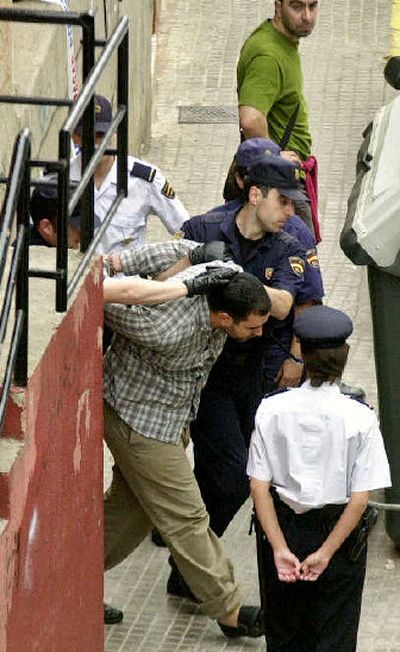 
Spanish police lead away a terror suspect in Santa Coloma de Gramenet near Barcelona, Spain, on Wednesday. 
 (Associated Press / The Spokesman-Review)