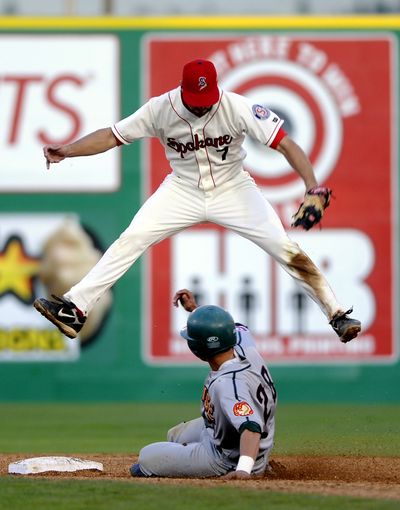 Boise’s Ryan Flaherty steals second base after Spokane shortstop Jacob Kaase leaps for a high throw.  (Jesse Tinsley / The Spokesman-Review)