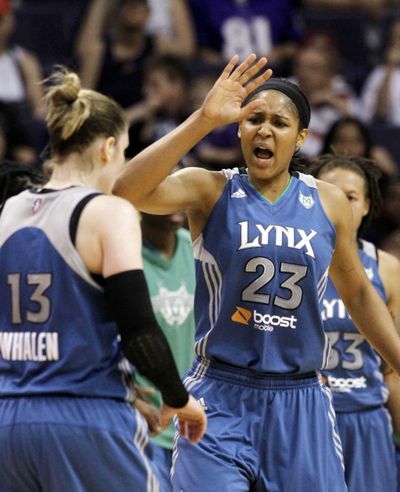 Maya Moore (23) celebrates a last-second basket by Lindsay Whalen during the second quarter of Minnesota’s win over Phoenix. (Associated Press)