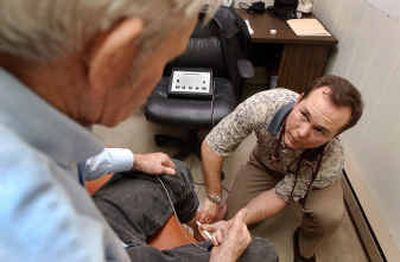 
Naturopathic physician Dr. Richard Powell, right, examines patient Don Hill of Gooding at Powell's Twin Falls office. 
 (Associated Press / The Spokesman-Review)
