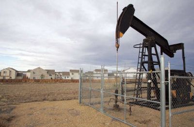 
An oil pump is shown near a house in Frederick, Colo. The national energy industry enjoyed a record-breaking year in 2006. 
 (Associated Press / The Spokesman-Review)
