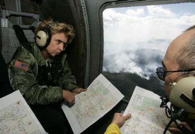 
Washington Gov. Chris Gregoire, left, is briefed by John Viada, northeast regional manager for the Washington state Department of Natural Resources, as they fly over the Tripod Complex fire in Conconully, northwest of Omak, on Wednesday. 
 (Associated Press / The Spokesman-Review)