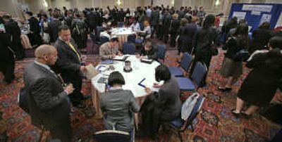 
Job seekers wait on line and fill out job applications while attending the Monster.com and National Career Fairs job fair this week in New York. The Labor Department on Thursday said new applications filed for unemployment insurance rose by 4,000 to 372,000 last week.Associated Press
 (Associated Press / The Spokesman-Review)