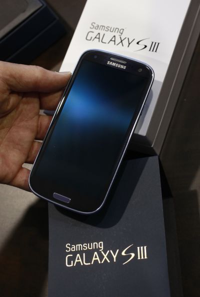 A customer checks out a Samsung Galaxy S III phone at a Best Buy store in Mountain View, Calif. (Associated Press)