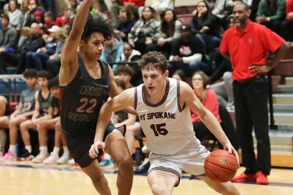 Mt. Spokane forward Maverick Sanders drives past North Central’s JuJu Ervin on Saturday.  (CHERYL NICHOLS/For The Spokesman-Review)