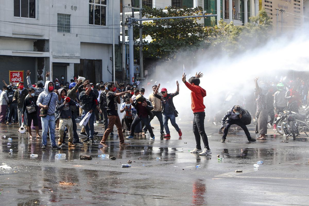 Police use water cannon to disperse demonstrators during a protest in Mandalay, Myanmar, Tuesday, Feb. 9, 2021. Police were cracking down on the demonstrators against Myanmar’s military takeover who took to the streets in defiance of new protest bans. (STR)