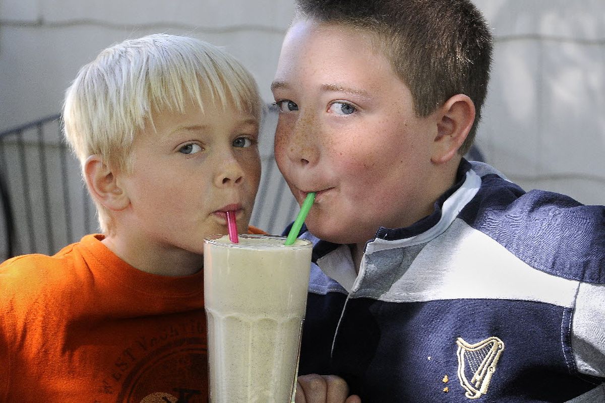 Ben Stone, 8, and William Condon, 10, sample an espresso shake from The Scoop in Spokane. The shake is made from vanilla ice cream from the Brain Freeze Creamery and a double shot of espresso from Bumper Crop Coffee. (Dan Pelle)