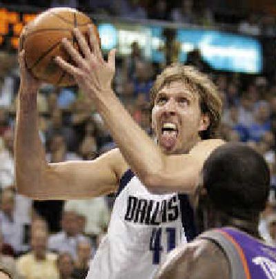 
Dallas' Dirk Nowitzki drives to the basket against Phoenix's Tim Thomas. 
 (Associated Press / The Spokesman-Review)