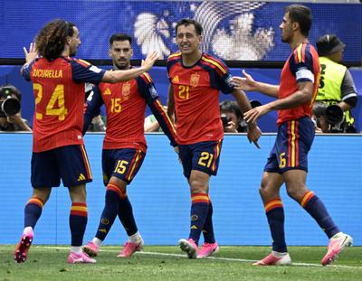 Spain forward Mikel Oyarzabal (21) celebrates with teammates after scoring to give Spain a 1-0 first half lead over Austria at Los Angeles Stadium in Inglewood, California, on July 2.  (Tribune News Service)