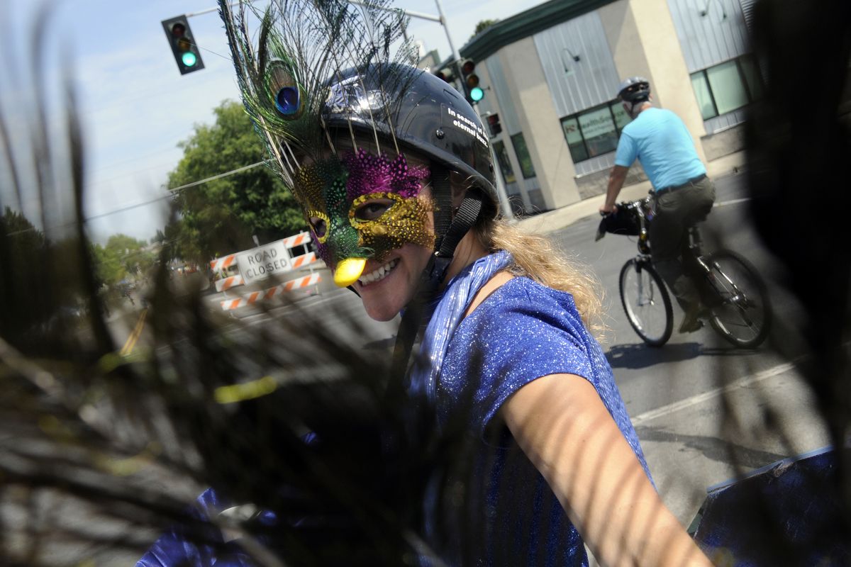 Liorah Wichser decorated her bicycle with peacock feathers for  Sunday’s Summer Parkways. About 40 people took part in a decorating contest. (J. BART RAYNIAK)