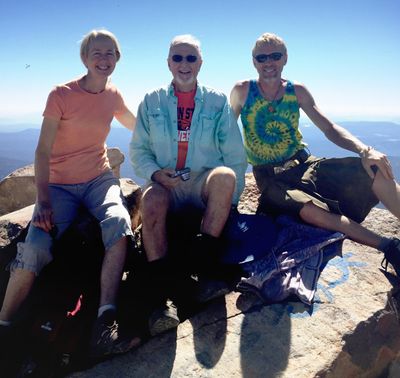 In this photo taken Sept. 15, 2015, Art Ekerson, center, sits on the summit of Mount McLoughlin for his 80th birthday near Butte Falls, Oregon,with his daughter, Cheryl Krieg, left, and son Kevin Ekerson, 45 years after the first time he led them to the summit. During the previous 41 times climbing to the top of Mount McLoughlin, Art Ekerson would soak up the views of Southern Oregon and Northern California in a panorama like none other. But trip No. 42 had a distinctly familial feel. (Art Ekerson / Associated Press)