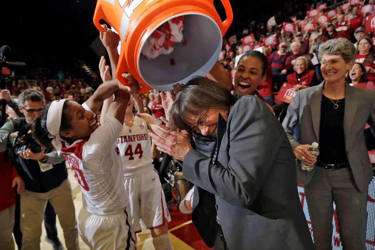 Stanford coach Tara VanDerveer, center, is doused with confetti by her players including Briana Roberson, left, and Erica McCall, second from right, after her 1,000th career win, in an NCAA college basketball game against Southern California on Friday, Feb. 3, 2017, in Stanford, Calif. (AP Photo/Marcio Jose Sanchez) ORG XMIT: CAMS115  (Marcio Jose Sanchez)