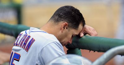 The New York Mets’ Carlos Beltran hangs his head on the dugout rail during a game in Pittsburgh.  (Associated Press / The Spokesman-Review)