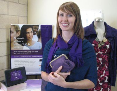 Erica Schreiber, women’s opportunity manager at the YWCA Spokane, holds one of the purses that’s part of the Purple Purse Campaign to raise awareness about domestic violence on Oct. 3. The campaign runs through October. (Pia Hallenberg)