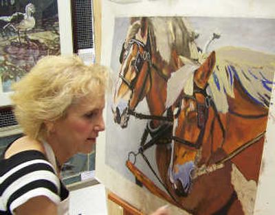 
Susie Snider paints a team of horses at the Bayview Local Artists Show and Tell last weekend.
 (Herb Huseland / The Spokesman-Review)