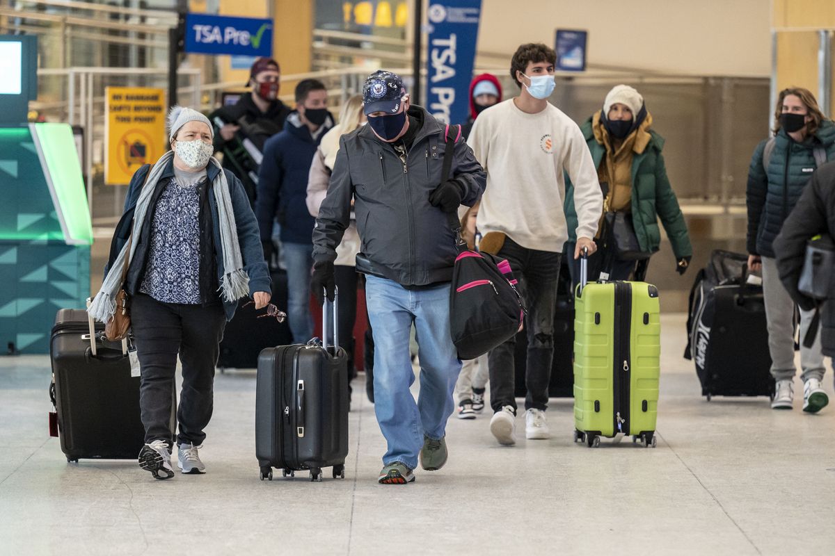 Arriving and departing travelers at the Spokane International Airport, some shown Wednesday, have faced numerous flight delays and cancellations this holiday season.  (COLIN MULVANY/THE SPOKESMAN-REVI)