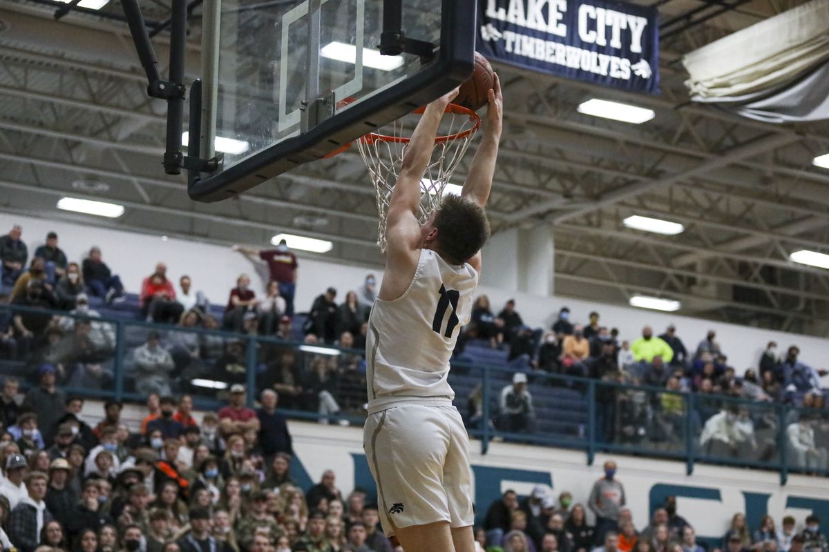 Lake City’s Zach Johnson dunks for two of his 12 points in a 63-47 victory against visiting Post Falls in the Idaho 5A District 1-2 title game on Tuesday.  (Cheryl Nichols/For The Spokesman-Review)