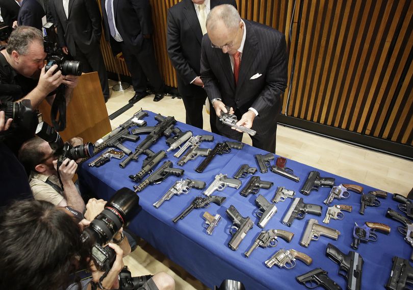 New York Police Commissioner Raymond Kelly looks at some of the guns seized as part of gun smuggling between the Carolinas and New York, Monday, Aug. 19, 2013 in New York. Authorities say couriers smuggled 254 guns into New York City by stashing weapons in their luggage on discount buses. The men were caught in a police sting that netted 254 weapons in 45 transactions since last year. (Mark Lennihan / Associated Press)