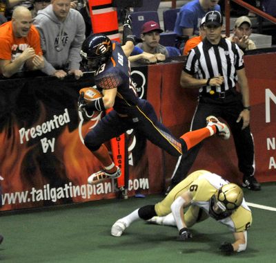 Shock wide receiver Justin Ore hurdles Iowa's Jason Simpson on a 34-yard touchdown pass in first quarter, but Barnstormers won in overtime. (Dan Pelle)