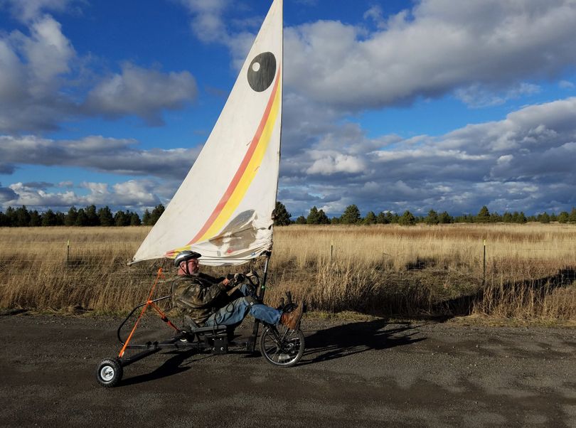 A man pedals-sails his home-made wind-powered tricycle near Airway Heights. (Rich Landers)