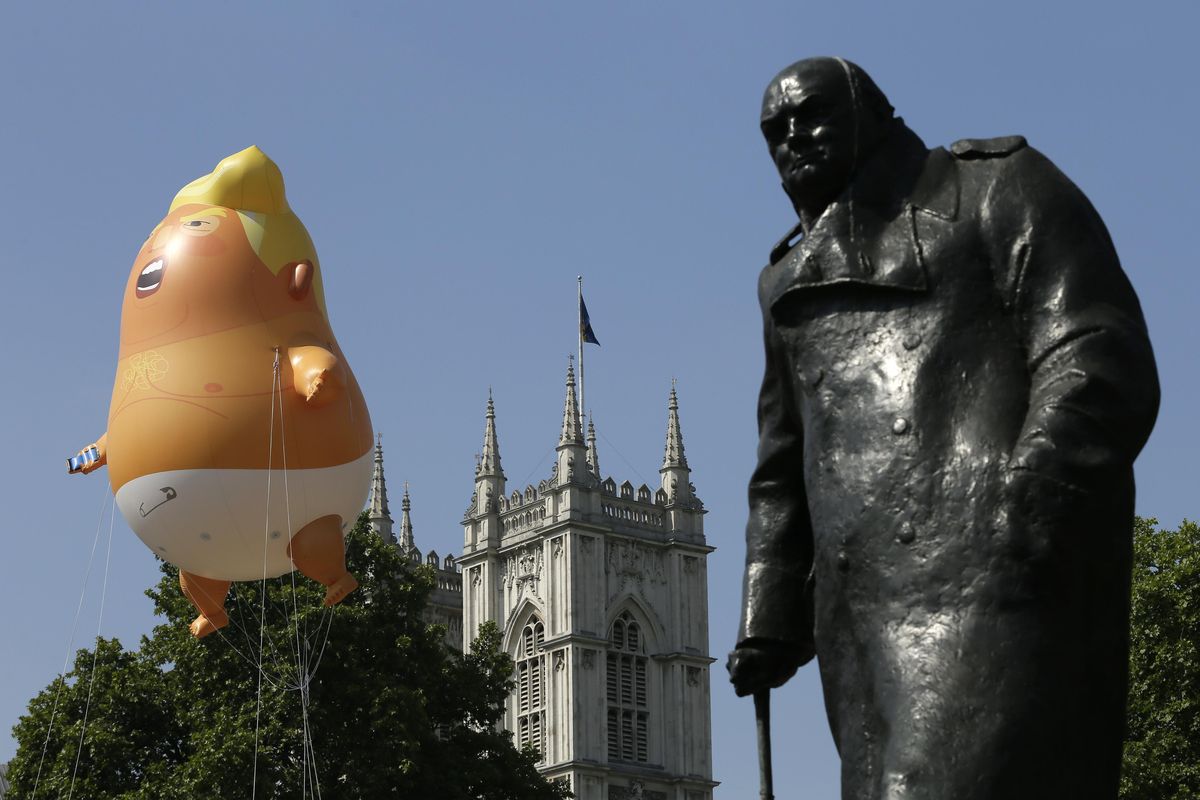 FILE – A six-meter high cartoon baby blimp of U.S. President Donald Trump hovers next to the statue of former British Prime Minister Winston Churchill, as it is flown as a protest against his visit, in Parliament Square in London, England, Friday, July 13, 2018. A replica of the balloon is expected to fly in Spokane next week during a visit by Vice President Mike Pence. (Tim Ireland / AP)