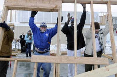 
Georges Eliow, second from right,  and volunteers raise the first wall of Eliow's Habitat for Humanity home Friday on East Union Avenue. 
 (Dan Pelle / The Spokesman-Review)