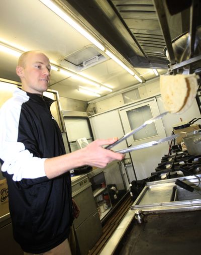 Chef Adam Korzun cooks in a trailer featuring a fully equipped kitchen capable of producing enough food for 150 people in Alta Badia, northern Italy. (Associated Press)