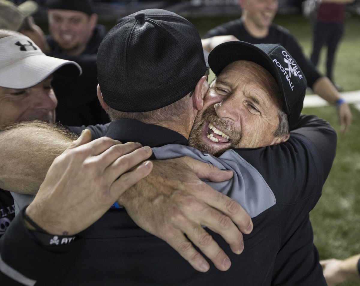 Colville head football coach Randy Cornwell get a hug after his team defeated Newport to win the 1A State football Championship. (Patrick Hagerty / For The Spokesman-Review)