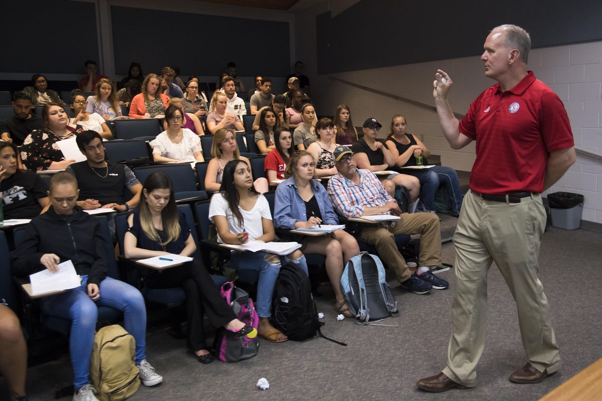 Otto Klein, senior vice president of the Spokane Indians baseball organization, speaks to a intercultural communications class at Eastern Washington University  about how his organization works with the Spokane Tribe over sensitive cultural issues like team logos. (COLIN MULVANEY/THE SPOKESMAN-REVIEW)