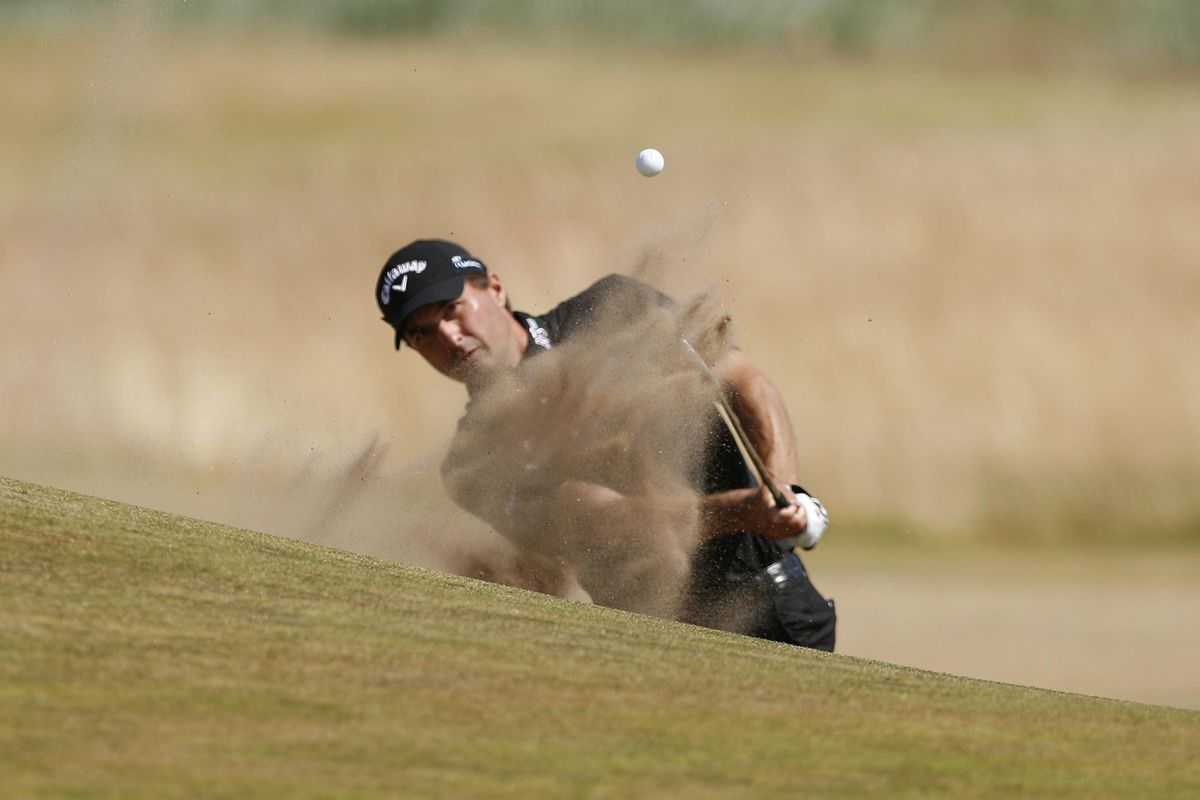 Kevin Kisner plays out of the bunker on the 17th hole during the first round of the British Open  in Carnoustie, Scotland, on Thursday. (Alastair Grant / AP)