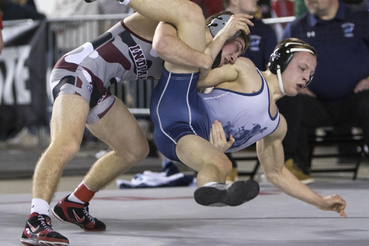 Colville’s Trent Baun, left, takes down Sultan’s Aidan Fleming during their 1A 132-pound match at Mat Classic XXXI on Saturday in Tacoma. Baun won the match 3-1 to become a four-time state champion. (Patrick Hagerty / For The Spokesman-Review)