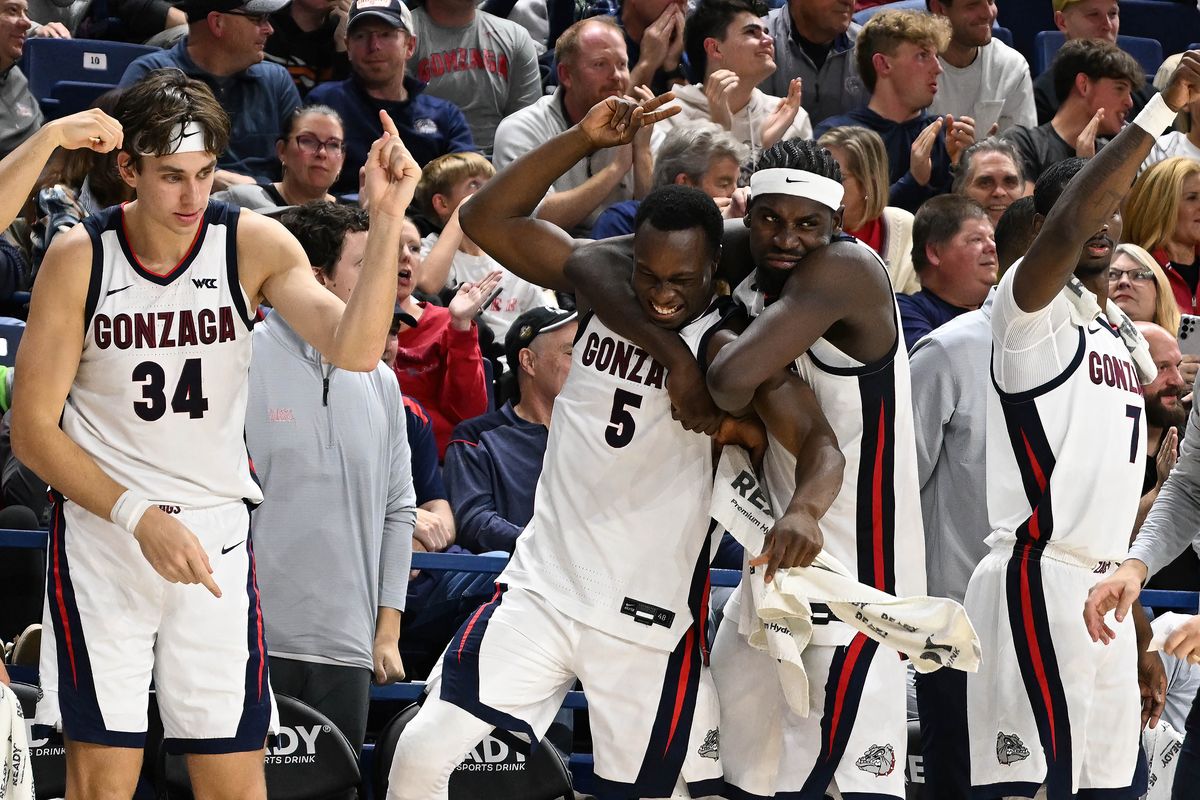 Gonzaga forward Emmanuel Innocenti (5) and forward Graham Ike (15) react to Gonzaga guard Davis Fogle (4) scoring his first point of the night during the second half of a NCAA college basketball game, Monday, Nov. 3, 2025, in the McCarthey Athletic Center. (COLIN MULVANY/THE SPOKESMAN-REVIEW)