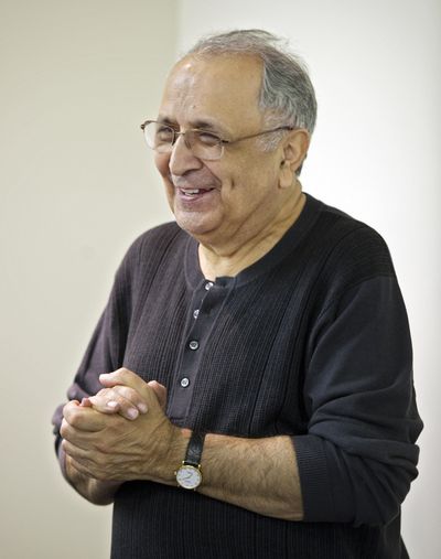 Reza Taghavi reacts to applause from family and friends at Los Angeles International Airport.  (Associated Press)