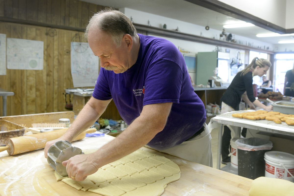 Mike Britton, who owns Mike’s Old Fashioned Donuts on East Sprague Avenue in Spokane Valley, cuts maple bars from dough during the morning rush on July 30. He starts around 3:30 a.m. each day and bakes until around 9:30. The shop closes at noon. (Jesse Tinsley)