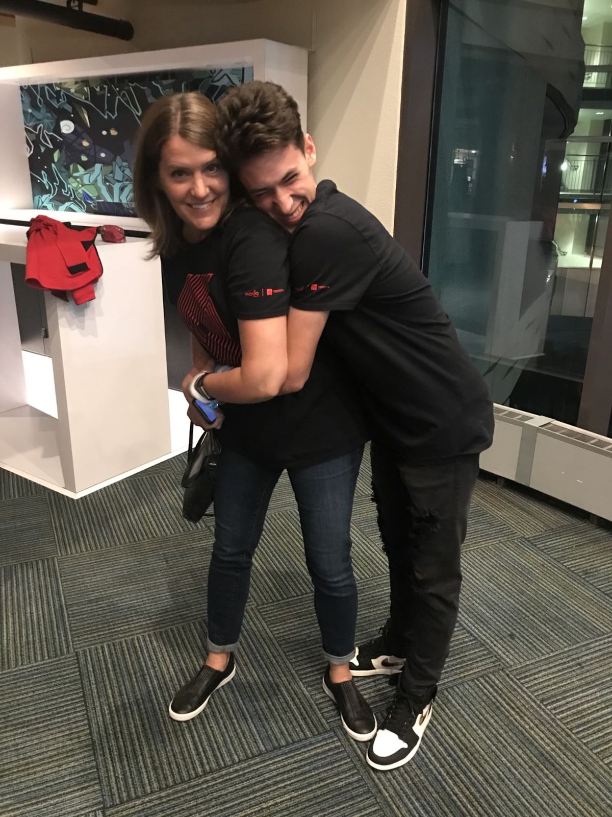 Hayden Fredrickson hugs his mother from behind at a Portland Trailblazers basketball game last year.   (Courtesy of Alix Fredrickson)