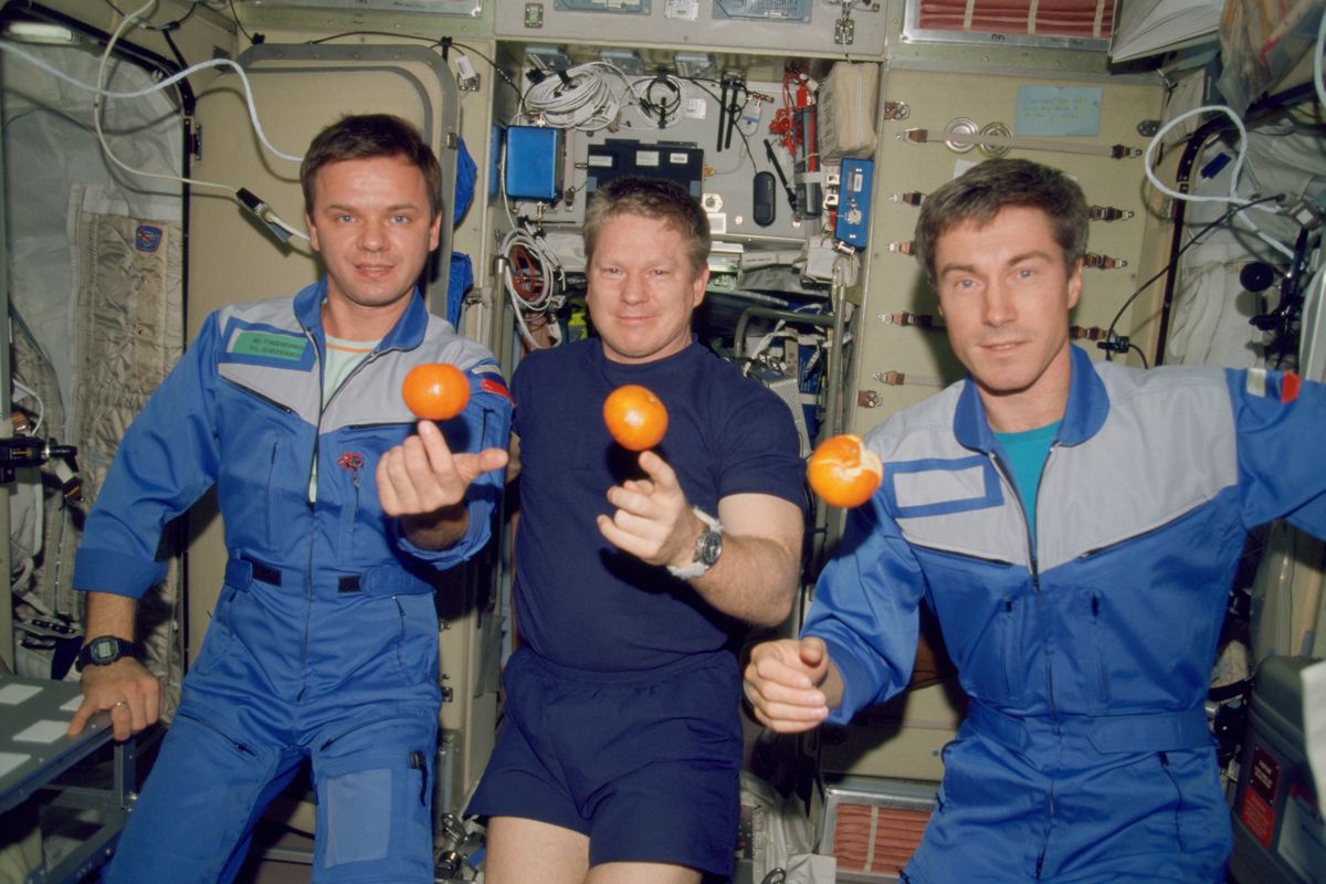 In this photo provided by NASA, the Expedition 1 crew members pose with fresh oranges onboard the Zvezda Service Module of the Earth-orbiting International Space Station on Dec. 4, 2000. Pictured, from left, are cosmonaut Yuri P. Gidzenko, Soyuz commander; astronaut Bill Shepherd, mission commander; and cosmonaut Sergei K. Krikalev, flight engineer.  (HOGP)
