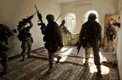 
U.S. Marines enter and search a  building in Fallujah on Saturday.
 (Associated Press / The Spokesman-Review)