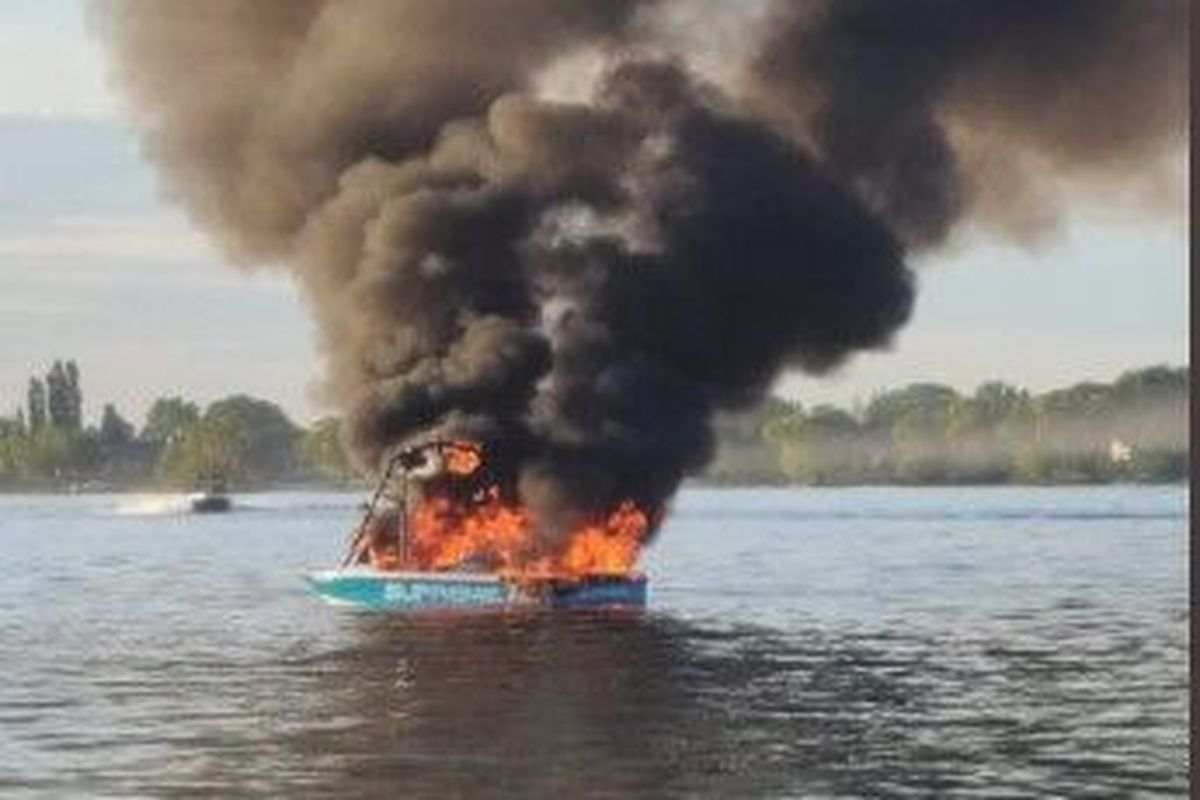 This boat caught fire on Moses Lake after the occupants reportedly harassed another boat that was flying a gay pride flag on Memorial Day. A TikTok video of the incident has gone viral with millions of views by Tuesday morning.  (Courtesy)
