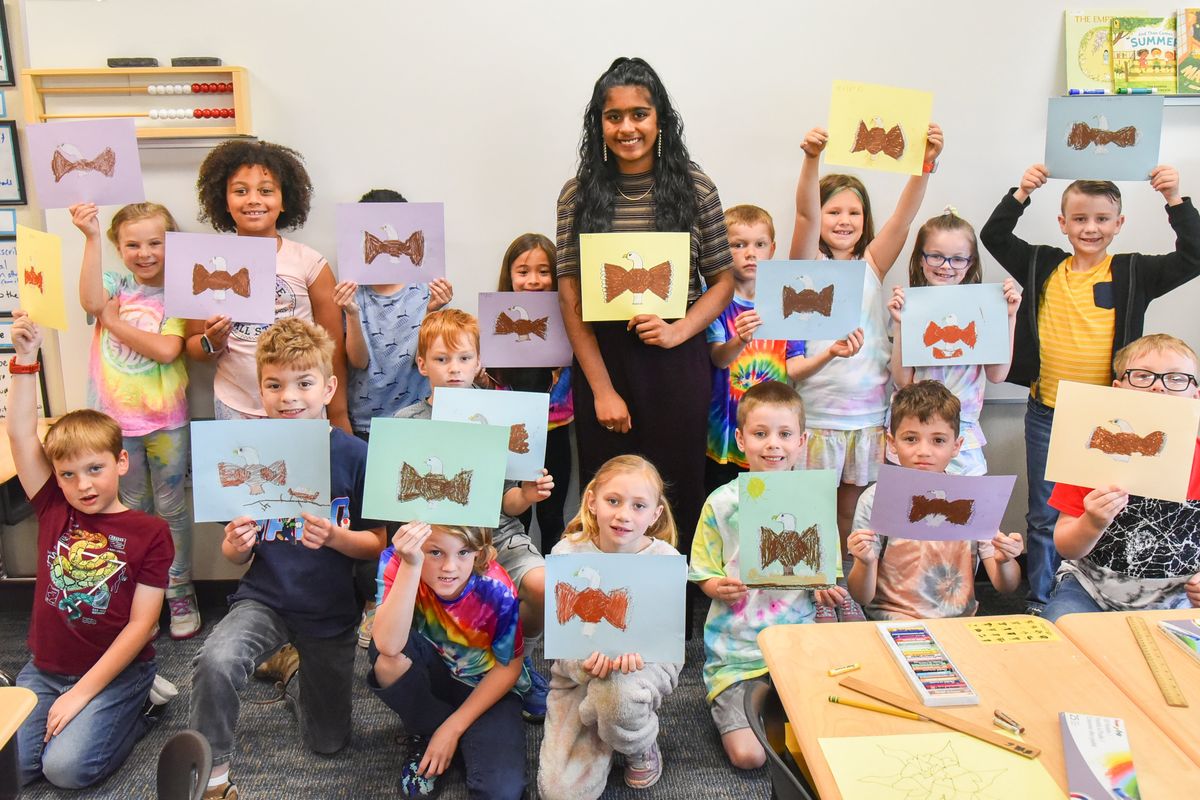 Sindhu Surapaneni, a Selkirk Middle School student, poses for a picture with the second-graders of Riverbend Elementary after teacher a lesson on how to draw a simple cartoon of an eagle Tuesday, June 14, 2022 at Riverbend. Surapaneni has been teaching art classes on a voluntary basis after she hear the school did not have a full-time art teacher.  (Jesse Tinsley/THE SPOKESMAN-REVIEW)