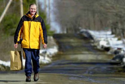 
Jimmy Hubbard walks along a rural road in Unity, Maine, on Feb. 17 as he has done for the past 25 years. 
 (Associated Press / The Spokesman-Review)