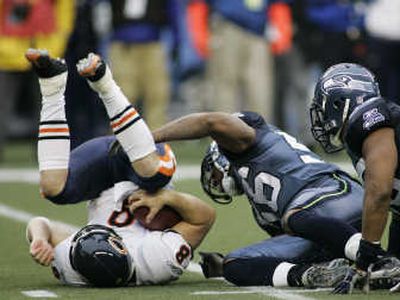 
Bears' quarterback Rex Grossman, left, is sacked by Seattle linebacker Leroy Hill in the third quarter of Sunday's game.Associated Press
 (Associated Press / The Spokesman-Review)