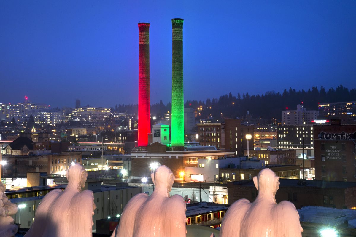 The Steam Plant stacks glow with red and green lights for the 2014 holidays in downtown Spokane.  (DAN PELLE/THE SPOKESMAN-REVIEW)