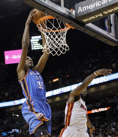 Oklahoma City’s Kevin Durant flies by Miami’s LeBron James. (Associated Press)