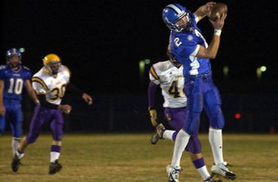 
Coeur d'Alene receiver Shea Vucinich beats Lewiston defender Nate Ebel and catches a 21-yard touchdown pass from Jake Hall during the first quarter of Friday's Inland Empire League game at Viking Field. 
 (Tom Davenport/ / The Spokesman-Review)