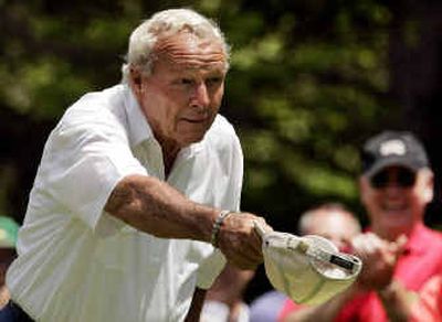 
 Arnold Palmer tips his cap to Fuzzy Zoeller for helping him pick a club at the 17th, where he had his only birdie Friday. 
 (Associated Press / The Spokesman-Review)