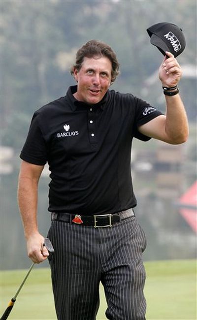 Phil Mickelson of the U.S. takes off his cap to greet spectators as he wins HSBC Champions golf tournament at Shanghai Sheshan International Golf Club Sunday, Nov. 8, 2009 in Shanghai, China. Mickelson finished at 17-under 271. (Eugene Hoshiko / AP Photos)