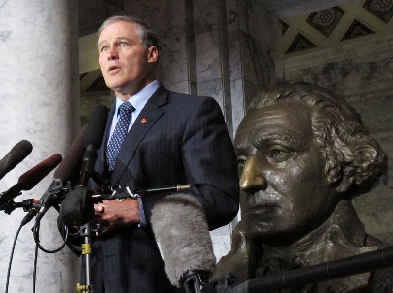 Washington Gov. Jay Inslee stands in front of a bust of George Washington in the Capitol rotunda in Olympia, Wash.  (AP Photo/Rachel La Corte)