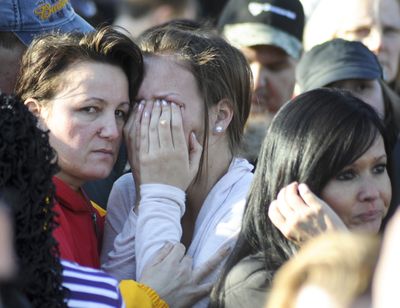 An unidentified student is united with a loved one in Omaha, Neb., on Wednesday outside the Millard South High School after a student shot two school administrators, one fatally. (Associated Press)